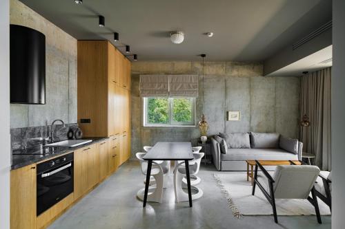 a kitchen and living room with a table and a couch at Rezident Tomis Marina in Constanţa