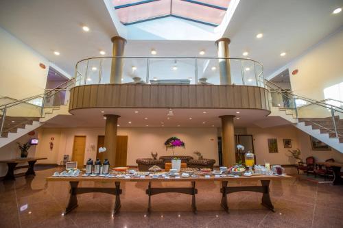 a large lobby with a table with food on it at Hotel Villa Rossa in São Roque