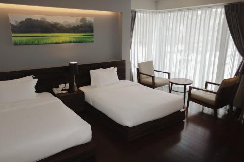 Postel nebo postele na pokoji v ubytování Terracotta Hotel & Resort Dalat