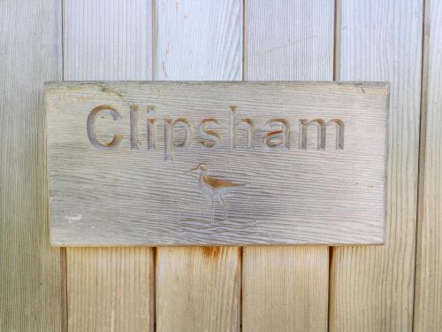 a sign on a fence with a bird on it at Clipsham in Cottesmore