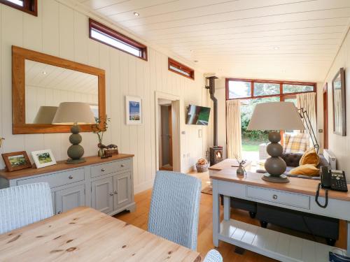 a dining room with a table and a mirror at Clipsham in Cottesmore