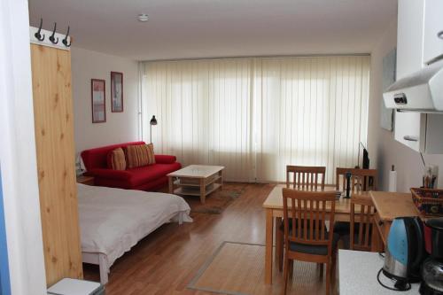 a living room with a bed and a dining room at Ferienappartement K315 für 2-4 Personen in Strandnähe in Schönberg in Holstein