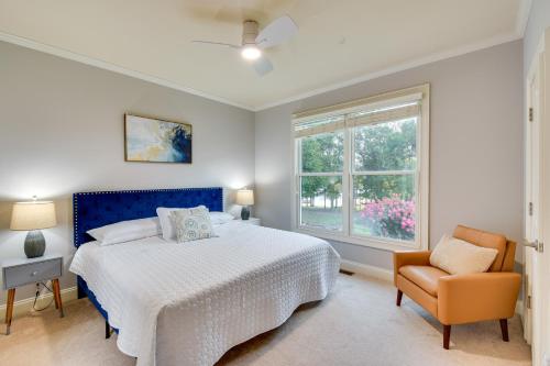 a bedroom with a bed and a chair and a window at Grand Lakefront Home in Hartwell with Game Room! in Hartwell