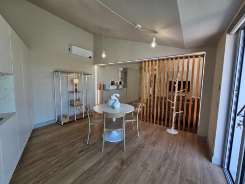 a room with a table and chairs in a room at Ca' del magu in San Michele Mondovì