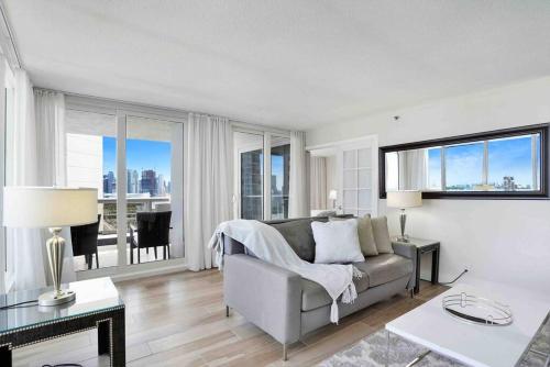 a living room with a couch and a table at Aqua Marina! Water & City Views! in Miami