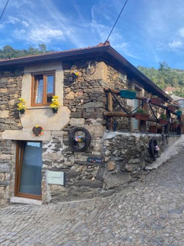 a stone building with a window on the side of it at Casa das Flores in Lamego