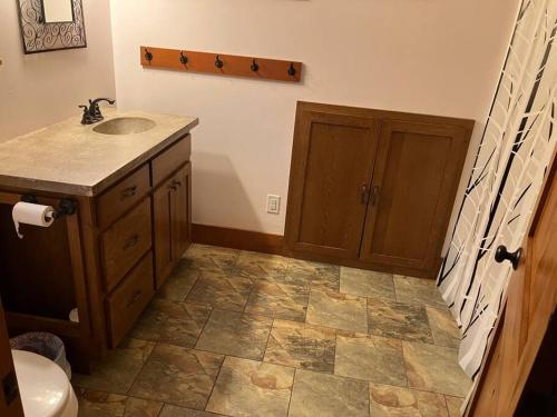 a bathroom with a sink and a toilet at Cozy Oaks Cabin 