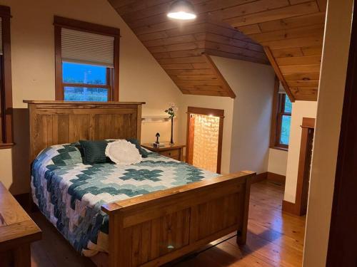 a bedroom with a large wooden bed in a house at Cozy Oaks Cabin 