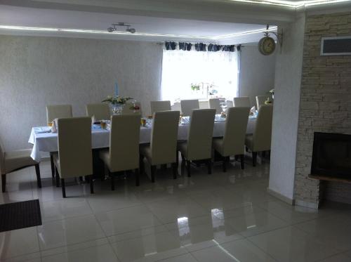 a dining room with a long table and chairs at Willa Szus in Koniaków
