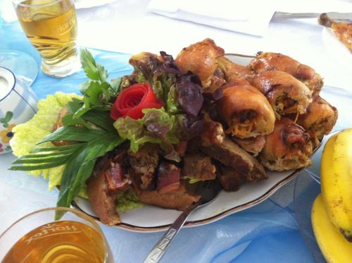 a plate of food with a salad on a table at Willa Szus in Koniaków