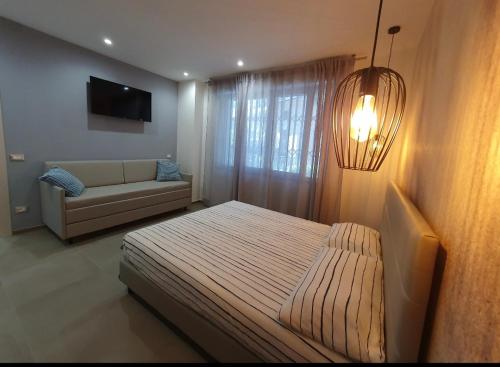 a bedroom with a bed and a couch at Playa degli Angeli Scirocco in Gabicce Mare