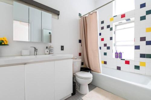 a bathroom with a sink and a toilet and a tub at 4BR in the heart of Tribeca in New York