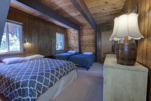 a bedroom with a bed and a lamp in a cabin at 2 bedroom and Loft, 2 bath, sleeps 6 Donner Lakefront with private dock DLR#013 in Truckee
