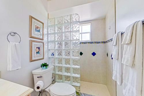 a bathroom with a toilet and a shower at Rock N' Reel Boat House in Saint James City
