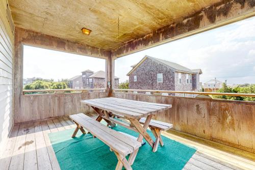 a picnic table on the balcony of a house at Salty Paws in Frisco