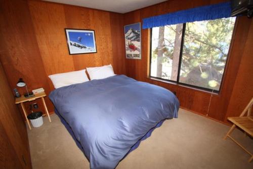 a bedroom with a large bed with a window at 2 bedroom, 2 bath, sleeps 6 Direct Donner Lake Access DLR#038 in Truckee