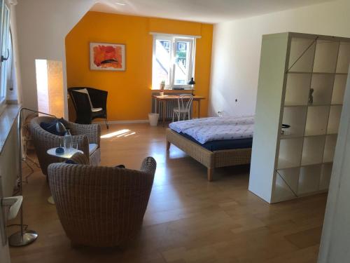 ein Schlafzimmer mit einem Bett und Stühlen in einem Zimmer in der Unterkunft Glück in Benrath in Düsseldorf