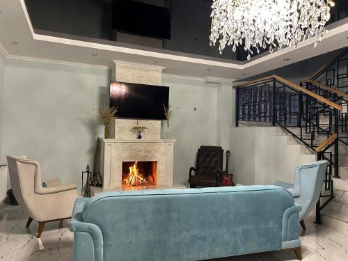 a living room with a couch and a fireplace at Orophile guest house in Gorists'ikhe