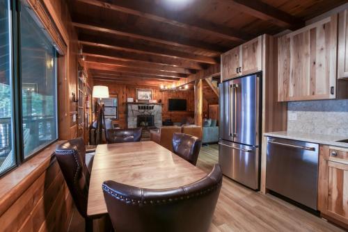 a kitchen and dining room with a wooden table and chairs at 3 bedroom, 2 bath Sleeps 8 adults Direct Lake Access DLR#041 in Truckee