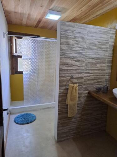 a bathroom with a shower with a towel on a wall at Varuna- en La Casa de Nanda in San Javier