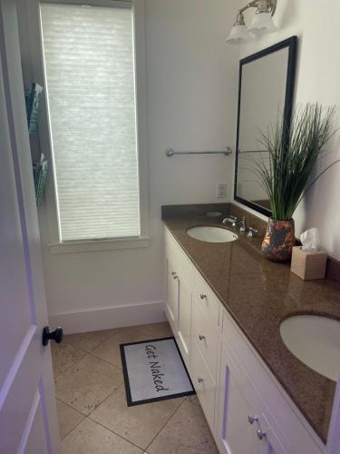 a bathroom with two sinks and a mirror at Moose Manor Guest Suite - Houston in Houston