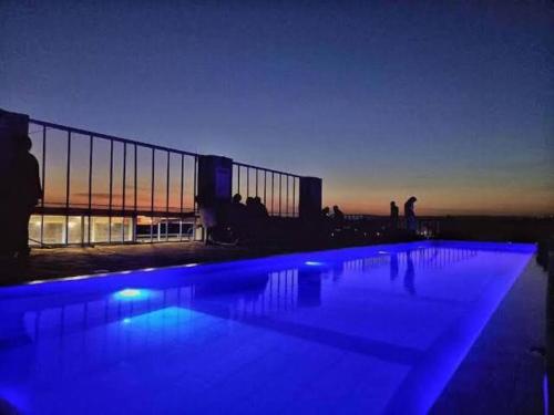 una piscina con iluminación azul por la noche en Gracie's Apartment, en Kiambu