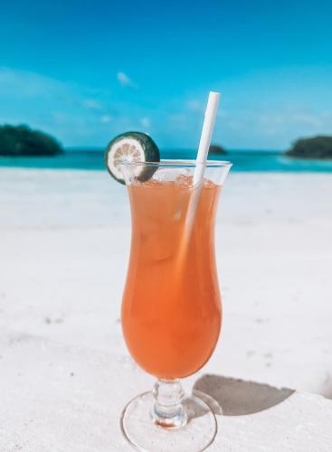 a drink on the beach with a slice of lime at Shaka Caye All inclusive Resort in Belize City
