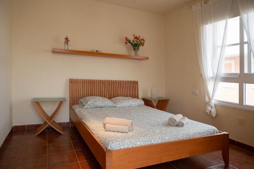 a bedroom with a bed with towels on it at VILLA ADELA in Callao Salvaje