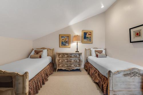 two beds in a room with white walls at Monterey Dune Haven in Moss Landing