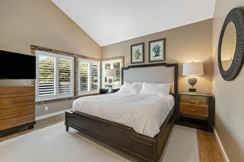 a bedroom with a large bed and a large mirror at Monterey Dune Haven in Moss Landing