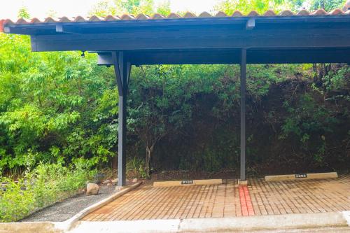 a pavilion with a blue roof with a cat under it at Bougainvillea 2101 in Playa Conchal