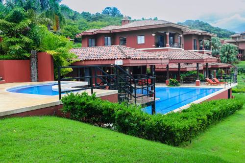 a house with a swimming pool in front of it at Bougainvillea 2101 in Playa Conchal