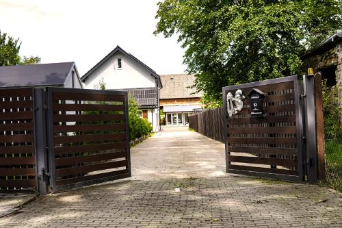 a pair of gates in front of a driveway at Holiday Home Vegas - HOUSE AND GARTEN FOR EXCLUSIVE USE in Kołczewo