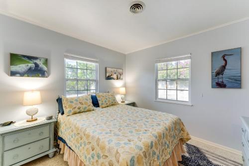 a bedroom with a bed and two windows at Pet-Friendly Venice Vacation Rental, 3 Mi to Beach in Venice