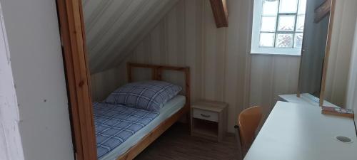 a small room with a small bed and a window at Ferienhaus Kastanienblick in Moselkern