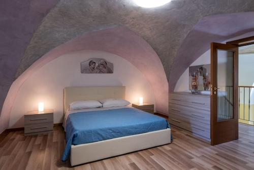 a bedroom with a bed with a purple ceiling at La casa di nonno Mario, Salento in Magliano