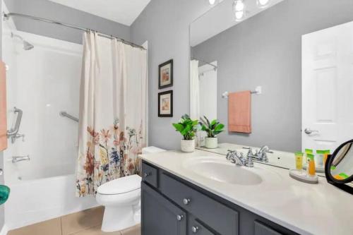 ein Bad mit einem Waschbecken, einem WC und einer Dusche in der Unterkunft A Luxurious Getaway Key Location in Orlando