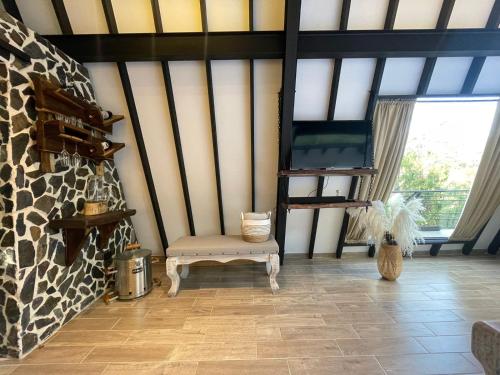 a room with a chair and a large window at Ecoluxury Glamping in San Antonio de Pereira