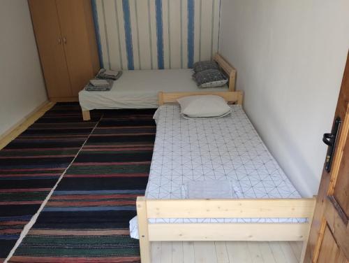 two twin beds in a small room at Втори километър in Ovcha Mogila