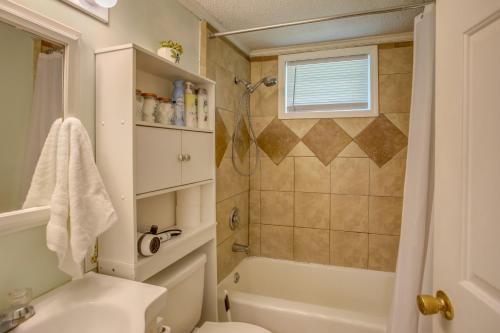 a bathroom with a shower and a toilet and a sink at Mid-Century Wilmington Cottage 3 Mi to Riverwalk in Wilmington