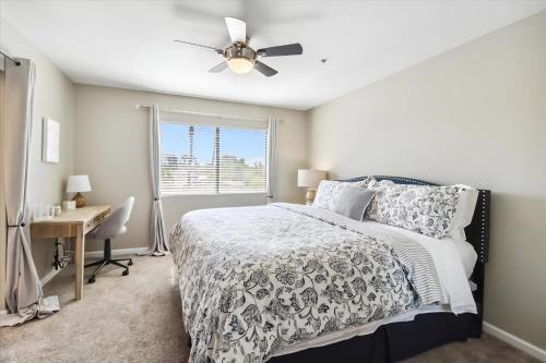 a bedroom with a bed and a desk and a window at Biltmore Bliss Desert Retreat! in Phoenix