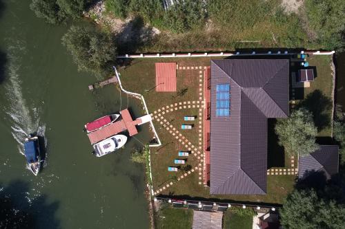 an aerial view of a house in the water at Eden Uzlina in Uzlina