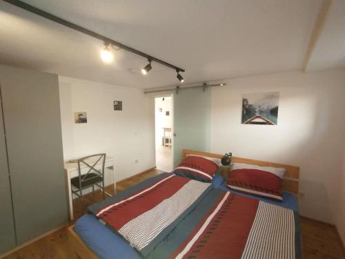 a bedroom with a bed and a desk in it at Schicke hundefreundliche Wohnung in Alsheim