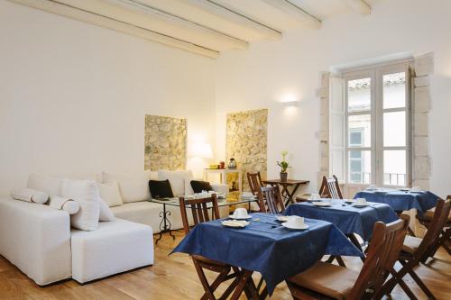 a living room with two tables and a couch at B&B Palazzo Del Sale in Siracusa