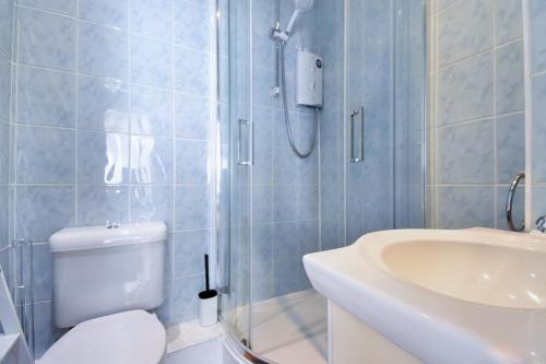 a bathroom with a shower and a toilet and a sink at Central Exeter's Perfect 2 BR Flat in Exeter