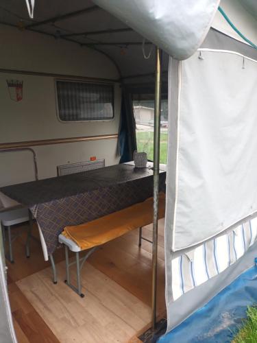 a table in the inside of an rv at Kemping prywatny na ośrodku in Gąski