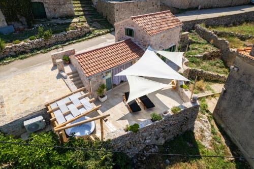 an aerial view of a house with a tent and chairs at Villa Teza Hvar in Hvar