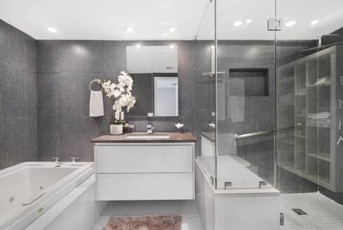 a bathroom with a tub and a sink and a shower at Seas The Day! Complete Panoramic Water Views in Miami