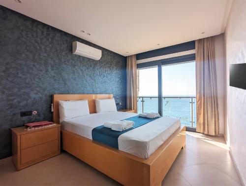 a bedroom with a large bed with a large window at RS Apartments - AL HOCEIMA in Al Hoceïma