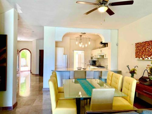 a dining room and kitchen with a table and chairs at CASA CANTO MARINA 20 up to 14 guest 7 brm in Puerto Vallarta